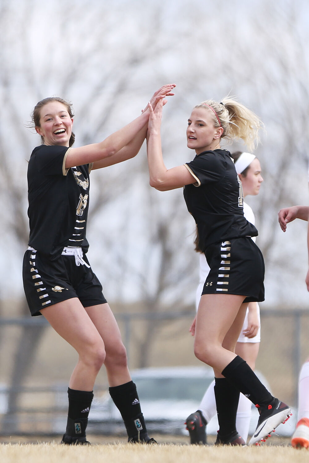 Vivi Ostheimer high fives senior Kendra Schultze